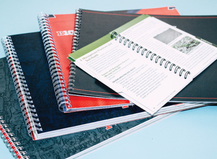 "Examples of binding methods (saddle stitch, perfect binding) and finishing techniques (embossing, laminating) in print production"